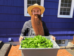Grant from Till Next Time Farms with freshly harvested spinach
