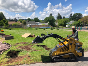 Sitton Elementary side view Skid steer operator about to cut path