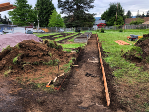 Sitton Elementarylow shot of trench cut for ADA path with wooden frames installed along length