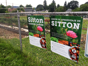 Garden Rules signs in English and Spanish